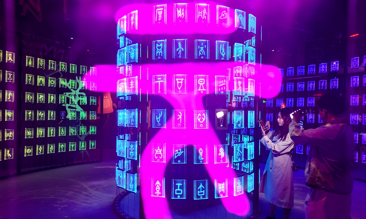 Visitors experience an immersive interactive oracle bone script digital exhibition at North China's Tianjin Museum on April 21, 2026. The museum's first fully immersive digital show uses advanced technology to bring to life the 3,000-year history of oracle bone inscriptions.