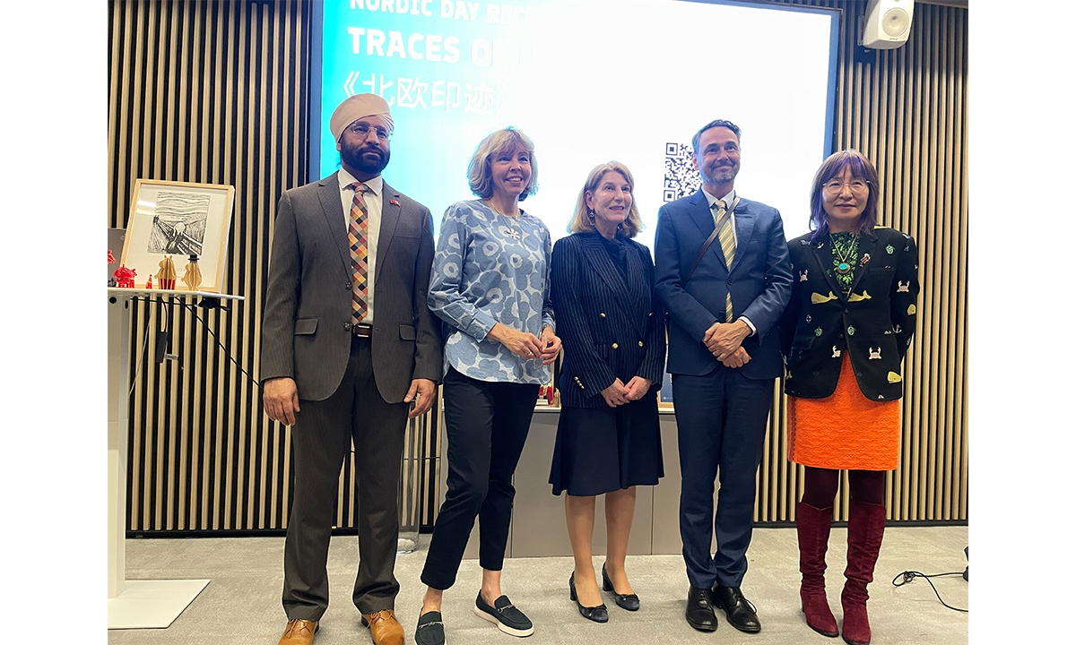 Anu Vuori (second from left), Consul General of Finland in Shanghai, takes a group photo with guests to the Traces of North exhibition held in Shanghai to celebrate the Nordic Day on March 23, 2026. Photo: Feng Yu/GT