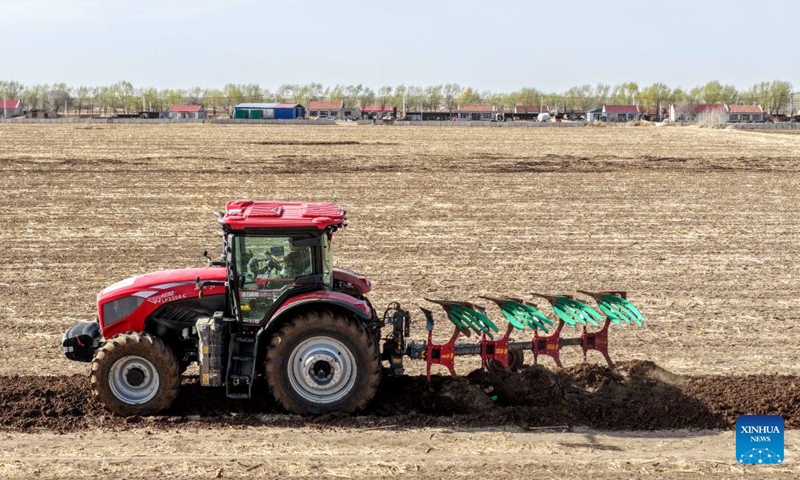 A drone photo taken on April 17, 2026 shows a farmer driving agricultural machinery to plough the fields in Horqin Left Wing Middle Banner of Tongliao City, north China's Inner Mongolia Autonomous Region. The ploughing work in Tongliao, a granary of eastern Inner Mongolia, is drawing to a close ahead of the peak period of corn sowing. It is learned that Tongliao's corn planting area in 2026 is expected to reach 20 million mu (1.33 million hectares). (Xinhua/Lian Zhen)

