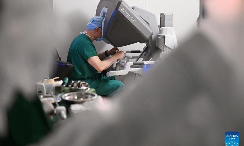 A doctor operates a da Vinci surgical robot at Tianjin Medical University Cancer Institute & Hospital in Tianjin, north China, April 19, 2026. In recent years, Tianjin Medical University Cancer Institute & Hospital has continued to advance its expertise in minimally invasive surgery. The hospital currently has three da Vinci surgical robots and has performed over 10,000 surgeries with the system, establishing a multidisciplinary minimally invasive treatment system. (Xinhua/Li Ran)

