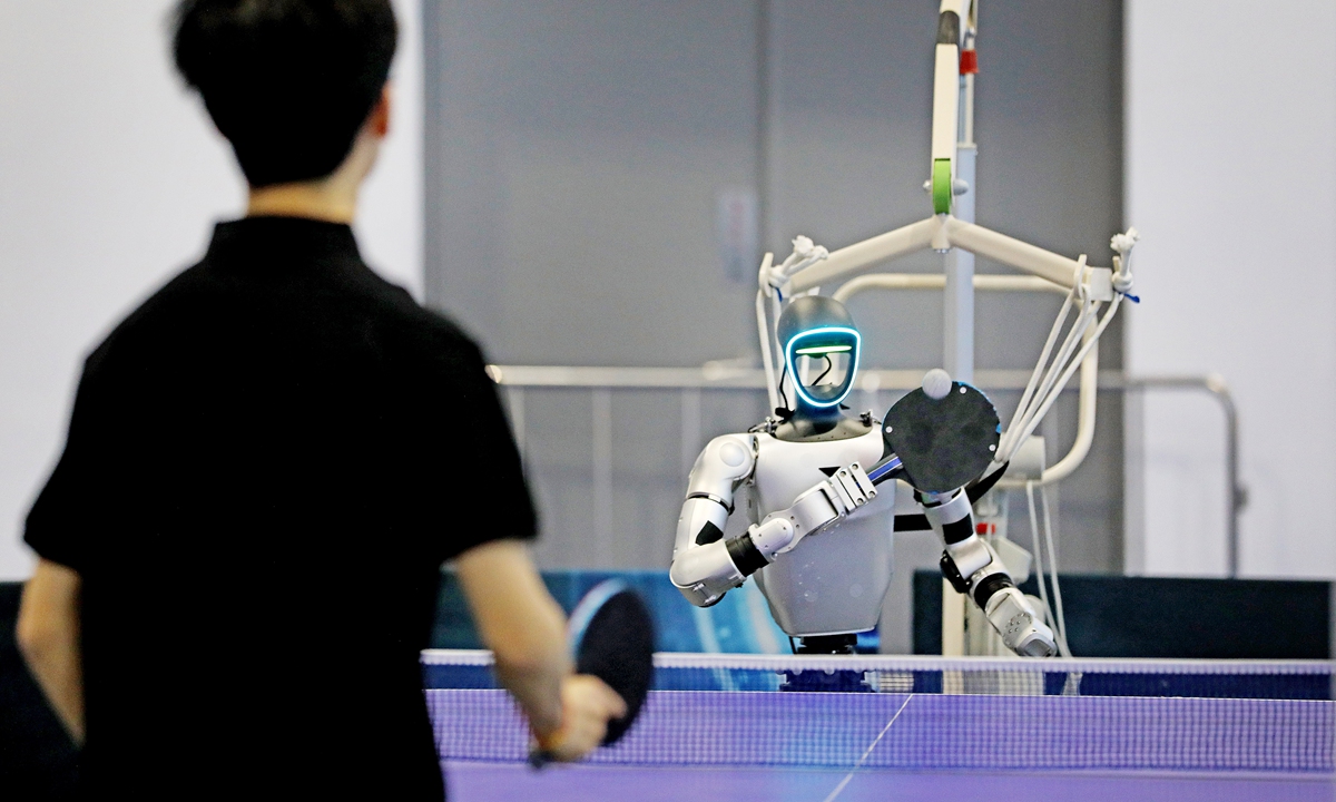 A person plays table tennis against an artificial intelligence (AI) robot at a unicorn innovation exhibition in Hangzhou, East China's Zhejiang Province, on April 22, 2026. The event highlights the full industrial chain of AI and embodied intelligence, bringing together leading global AI companies to showcase cutting-edge innovations and real-world applications. Photo: VCG