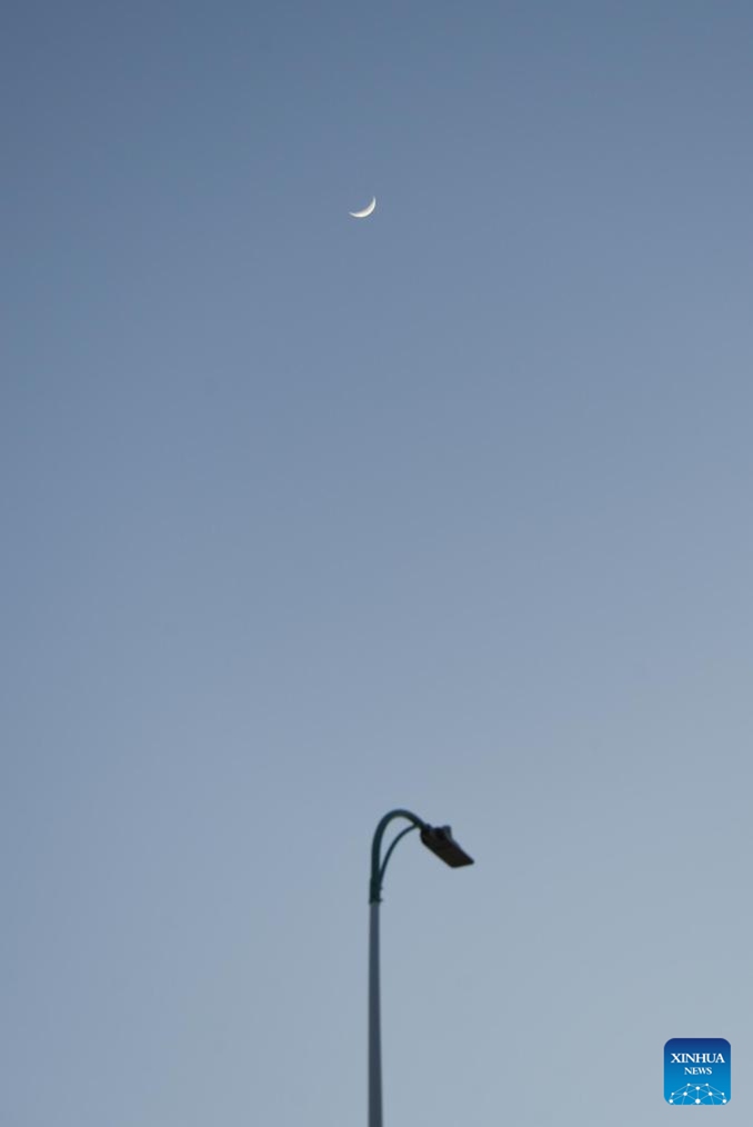 A waxing crescent moon is seen in the sky over Daqing, northeast China's Heilongjiang Province, April 21, 2026. (Photo by Wu Dayong/Xinhua)

