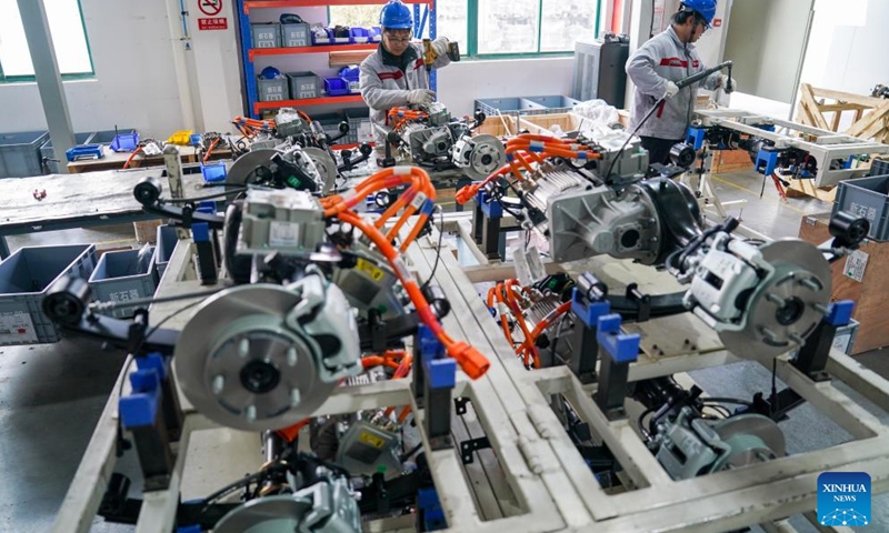 Staff members work on a production line of Neolix, an autonomous vehicle manufacturer, in Yancheng, east China's Jiangsu Province, March 25, 2026.