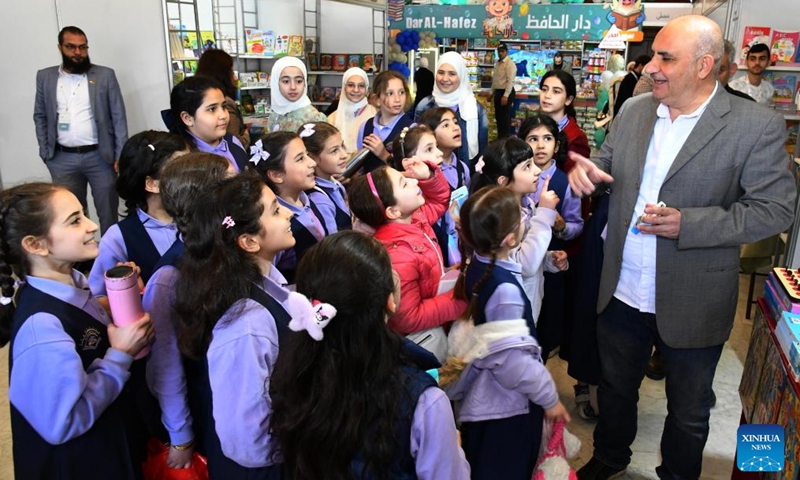 Syrian children attend a book fair at the National Library in Damascus, Syria, April 21, 2026. A book fair featuring activities such as group reading, chess, and painting was held here on Tuesday, aiming to promote reading and cultural awareness among the younger generation. (Photo by Ammar Safarjalani/Xinhua)

