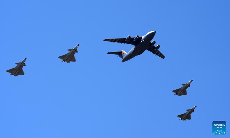 A Chinese Air Force Y-20B large transport aircraft carrying the remains of the fallen soldiers, escorted by four J-20 fighter jets, is pictured in Shenyang, northeast China's Liaoning Province, April 22, 2026. (Xinhua/Li Gang)