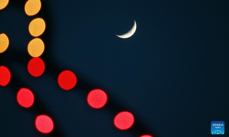 A waxing crescent moon is seen in the sky over Wudalianchi, northeast China's Heilongjiang Province, April 21, 2026. (Photo by Lu Wenxiang/Xinhua)


