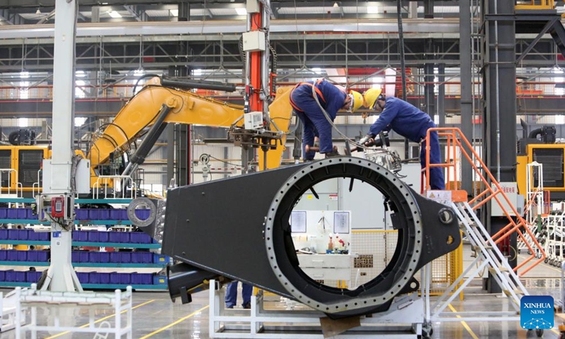 Staff members work at a workshop of Xuzhou Construction Machinery Group Co., Ltd. (XCMG) in Xuzhou City, east China's Jiangsu Province, on March 25, 2026. 