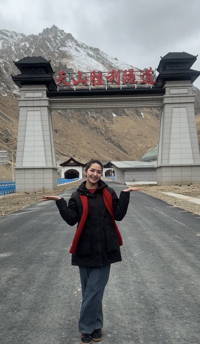 Xinjiang tour guide Dili post for a picture at the entrance of Tianshan Shengli Tunnel on April 20. Photo: courtesy of Dili 