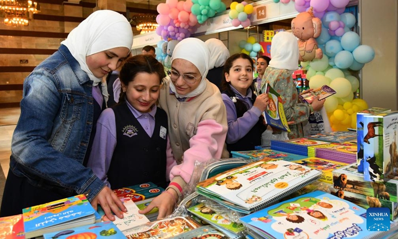Syrian children attend a book fair at the National Library in Damascus, Syria, April 21, 2026. A book fair featuring activities such as group reading, chess, and painting was held here on Tuesday, aiming to promote reading and cultural awareness among the younger generation. (Photo by Ammar Safarjalani/Xinhua)

