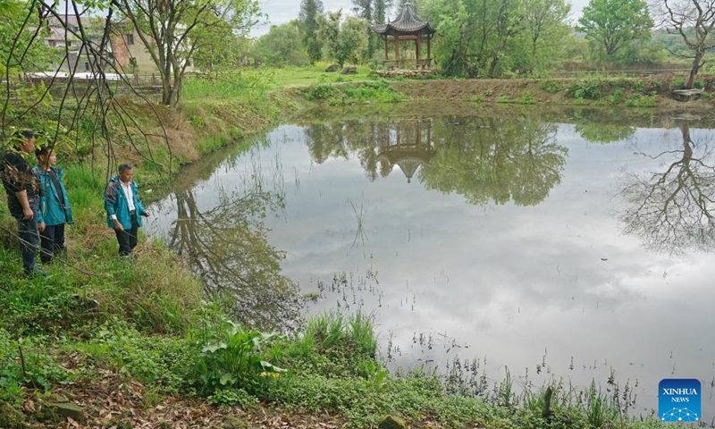 Xu Weishui (1st R) and villagers patrol beside a pond where fry were released in Dazizui Village of Duchang County, east China's Jiangxi Province, April 9, 2026.

