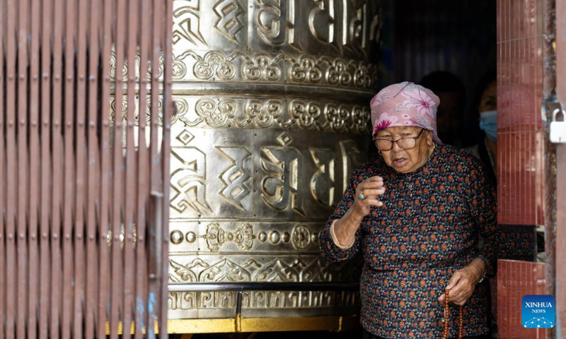 A woman takes part in rituals during the Buddha Jayanti festival at Swayambhunath Stupa in Kathmandu, Nepal, May 1, 2026. Buddha Jayanti is a sacred festival commemorating the birth, attainment of enlightenment, and death of Buddha on the full moon day in the Nepali month of Baishakh each year. (Photo by Sulav Shrestha/Xinhua)