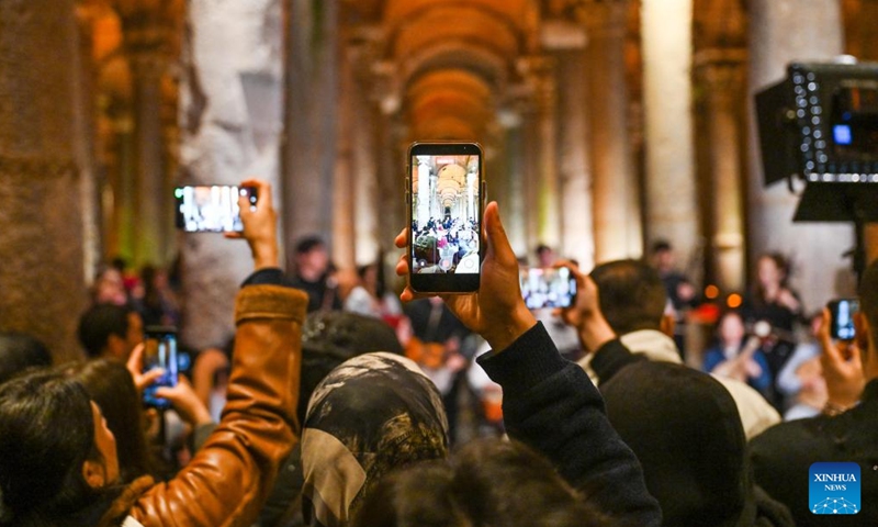 Visitors take photos of a flash mob performance of Chinese folk music at Basilica Cistern in Istanbul, Türkiye, April 22, 2026. Nanjing University's traditional instrument orchestra, in collaboration with the Confucius Institute at Bogazici University, staged a flash mob performance of Chinese folk music here on Wednesday, attracting many visitors. (Xinhua/Liu Lei)


