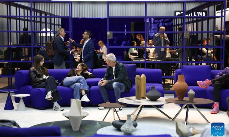Exhibitors communicate during the 64th Salone del Mobile at Fiera Milano Rho exhibition center in Milan, Italy, April 22, 2026. The 64th Salone del Mobile, an international furniture and design industry event, is held here from April 21 to 26. (Xinhua/Li Jing)

