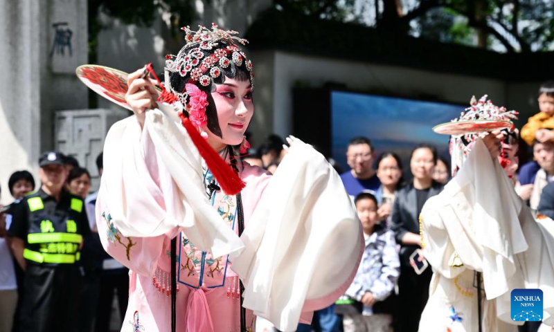 Actors of Minju Opera stage a flash mob performance in the Shangxiahang traditional block in Fuzhou, southeast China's Fujian Province, May 2, 2026. Local authorities have introduced a series of diverse programs and events that enable tourists to experience the charm of traditional culture and custom during the May Day holiday that started on May 1. (Xinhua/Lin Shanchuan)