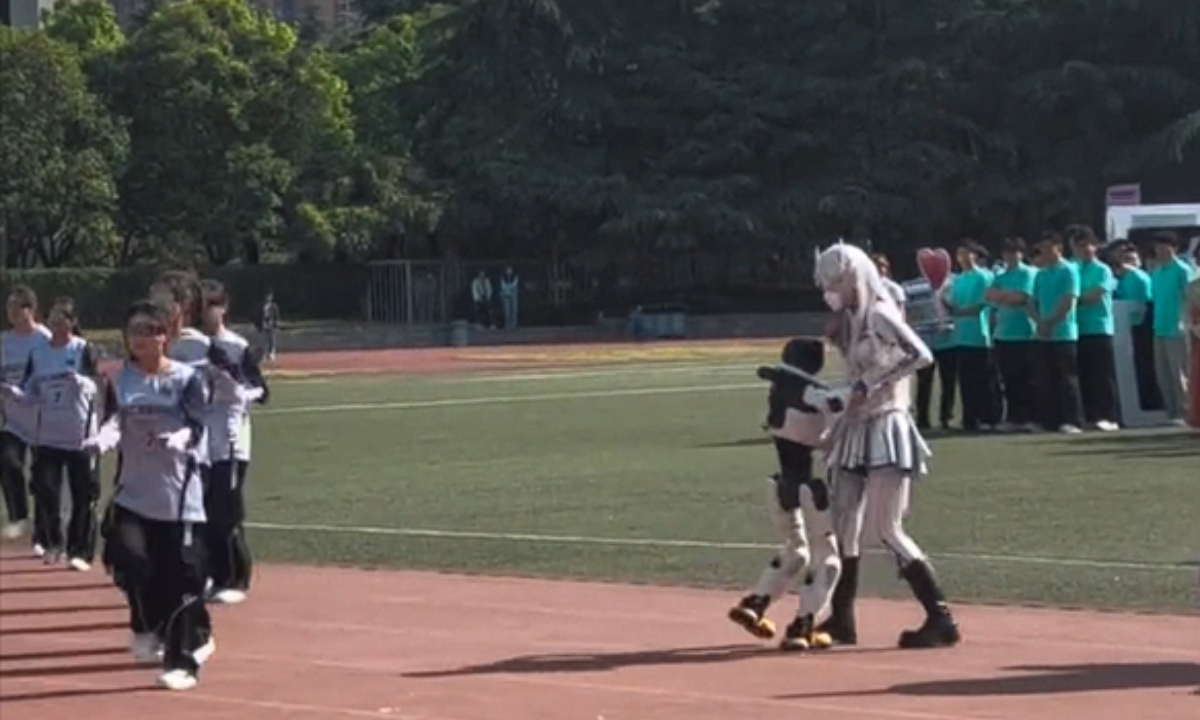 A humanoid robot, after suddenly deviating from its choreographed routine, turns and embraces a student during a dance performance at a university sports event in Xi’an, Northwest China’s Shaanxi Province, before on-site staff intervene. Photo: Video screenshot from Shangyou News