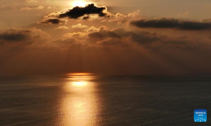 An aerial drone photo taken on April 24, 2026 shows the sunset scenery in the territorial waters of China's Huangyan Dao in the South China Sea. (Xinhua/Chen Bin)