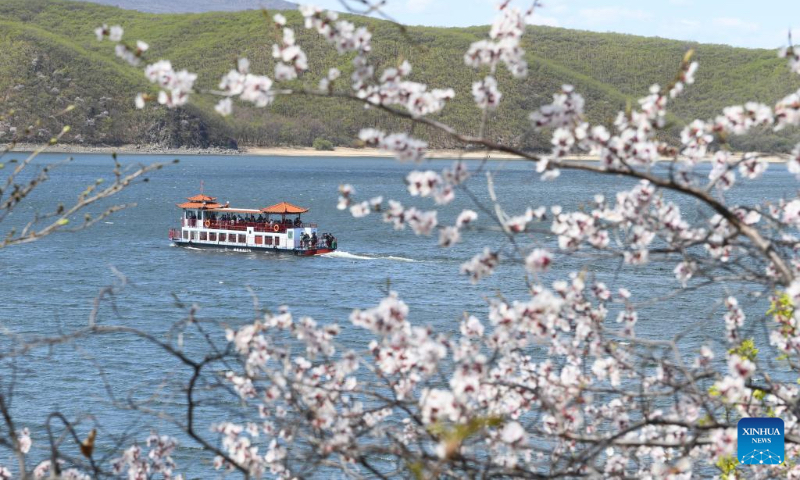 Tourists enjoy scenery aboard a boat on Jingbo Lake in Mudanjiang City, northeast China's Heilongjiang Province, on May 2, 2026. People across the country are going outdoors to enjoy the five-day May Day holiday, which began on May 1. (Photo by Zhang Chunxiang/Xinhua)
