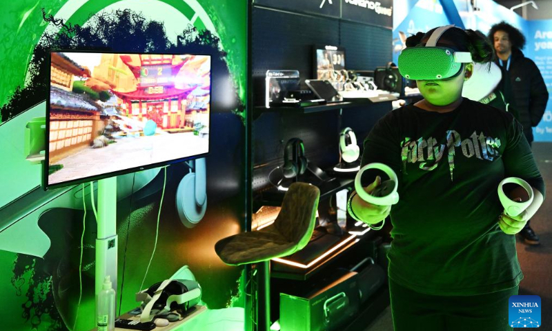 A visitor wearing digital glasses experiences a 3D video game at Comic Con Cape Town 2026 in Cape Town, South Africa, May 2, 2026. The 2026 edition of Comic Con Cape Town, a major pop culture and gaming event in Africa, took place here from April 30 to May 3. (Photo by Xabiso Mkhabela/Xinhua)