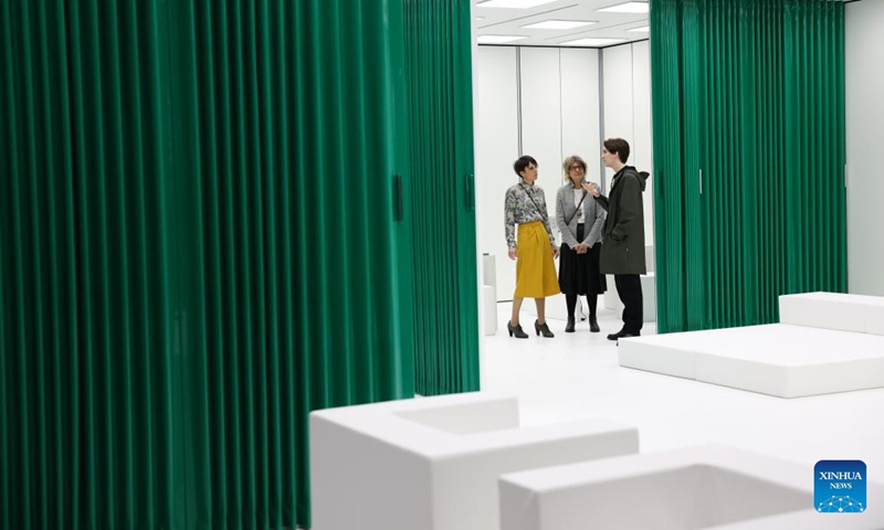 Exhibitors communicate during the 64th Salone del Mobile at Fiera Milano Rho exhibition center in Milan, Italy, April 22, 2026. The 64th Salone del Mobile, an international furniture and design industry event, is held here from April 21 to 26. (Xinhua/Li Jing)

