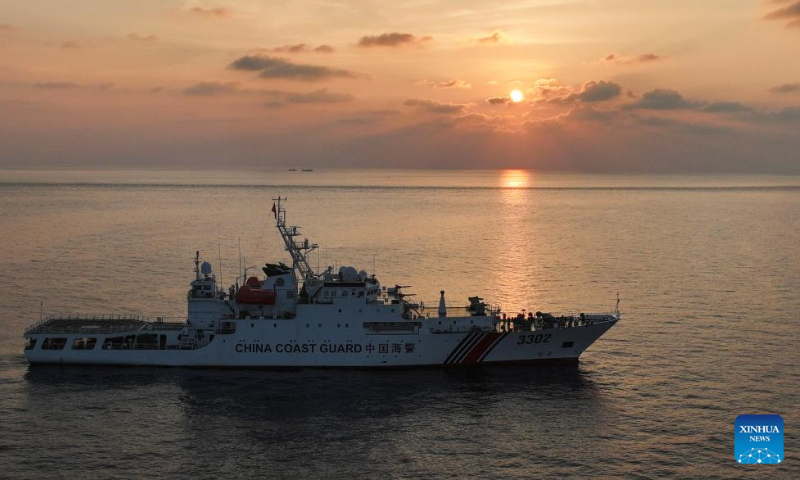 A drone photo taken on April 24, 2026 shows the China Coast Guard (CCG) vessel Chuanshan patrolling at sunset in the territorial waters of China's Huangyan Dao in the South China Sea. (Xinhua/Chen Bin)