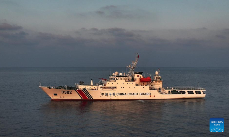 A drone photo taken on April 24, 2026 shows the China Coast Guard (CCG) vessel Chuanshan patrolling at sunset in the territorial waters of China's Huangyan Dao in the South China Sea. (Xinhua/Chen Bin)