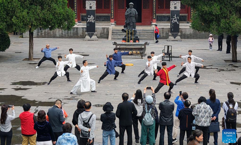 A drone photo taken on May 2, 2026 shows tourists watching a Taiji-themed melodrama at Chenjiagou scenic area in Jiaozuo City, central China's Henan Province. People across the country are going outdoors to enjoy the five-day May Day holiday, which began on May 1. (Photo by Xu Hongxing/Xinhua)
