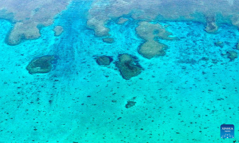 An aerial drone photo shows reefs in the territorial waters of China's Huangyan Dao in the South China Sea at sunset on April 24, 2026. (Xinhua/Chen Bin)