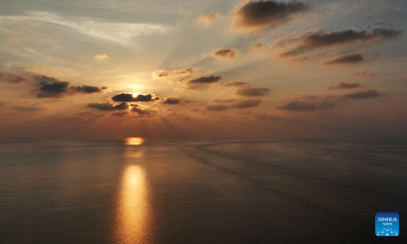 An aerial drone photo taken on April 24, 2026 shows the sunset scenery in the territorial waters of China's Huangyan Dao in the South China Sea. (Xinhua/Chen Bin)