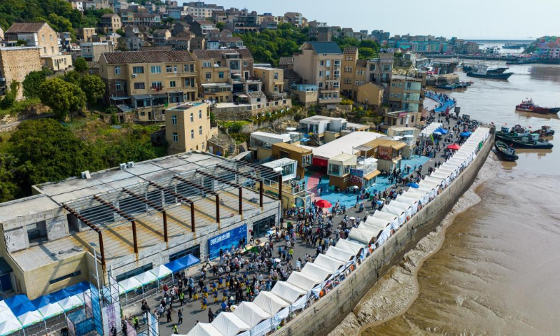 An aerial drone photo taken on May 2, 2026 shows a performance during a parade in Liruo Village, Shitang Town, Wenling City, east China's Zhejiang Province. Shitang Town, located in Wenling City of Zhejiang Province, is a traditional fishing port surrounded by the sea on three sides. During this year's May Day holiday, the town hosted a variety of fishing culture activities, drawing tourists from across the country. (Xinhua/Jiang Han)
