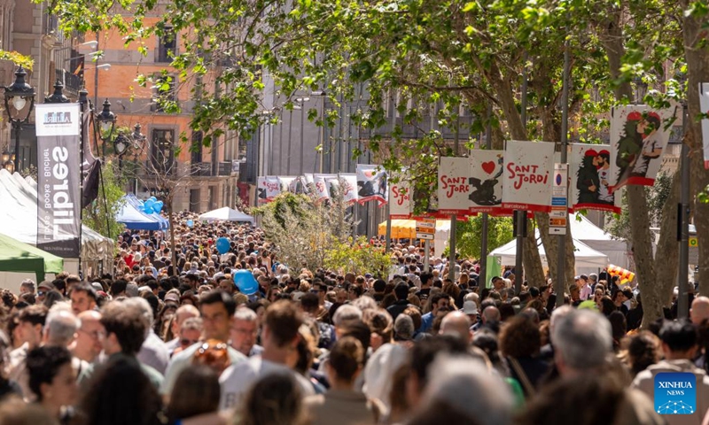 People crowd on the street to celebrate Sant Jordi in Barcelona, Spain, April 23, 2026. Large crowds filled the Spanish city of Barcelona on Thursday as people took to the streets to celebrate Sant Jordi, a traditional festival combining romance and reading. (Photo by Joan Gosa/Xinhua)