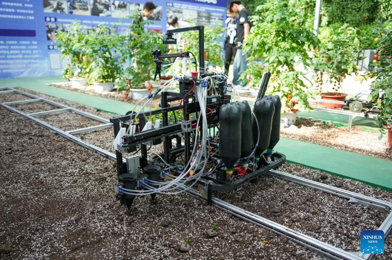 A seedling planting robot is seen at the 27th China (Shouguang) International Vegetable Science and Technology Expo in Shouguang, east China's Shandong Province, April 20, 2026. Featuring more than 50 types of agricultural robots in its booth for digital agriculture, this year's expo allow visitors to peep into the future of unmanned farming. (Xinhua/Xu Suhui)