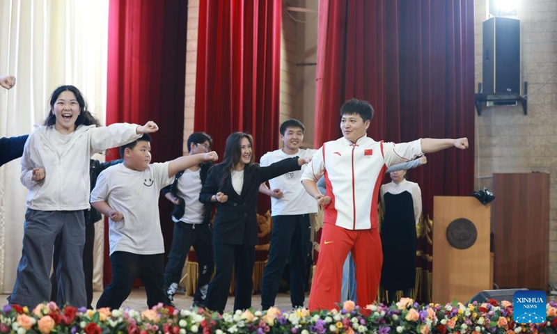Shi Longlong (1st R), world champion of Wushu, teaches spectators during the Charm of Chinese Kung Fu in Bishkek, Kyrgyzstan, April 23, 2026. (Photo by Roman/Xinhua)