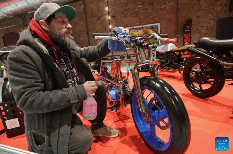 A man cleans his motorcycle during the St. Petersburg Motorcycle Exhibition in St. Petersburg, Russia, on April 24, 2026. (Photo by Irina Motina/Xinhua)