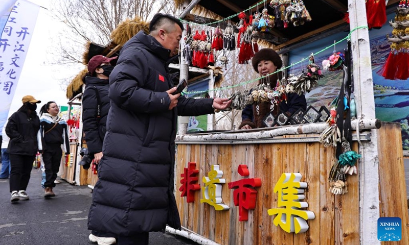 People select products at an intangible cultural heritage fair during the Kaijiang folk culture week in Tongjiang City, northeast China's Heilongjiang Province, April 25, 2026. Tongjiang kicked off the Kaijiang folk culture week on Saturday, where diverse activities including traditional performances were staged to showcase the region's ethnic heritage.

Kaijiang refers to the annual springtime thawing of ice-covered rivers in northeast China. Photo: Xinhua