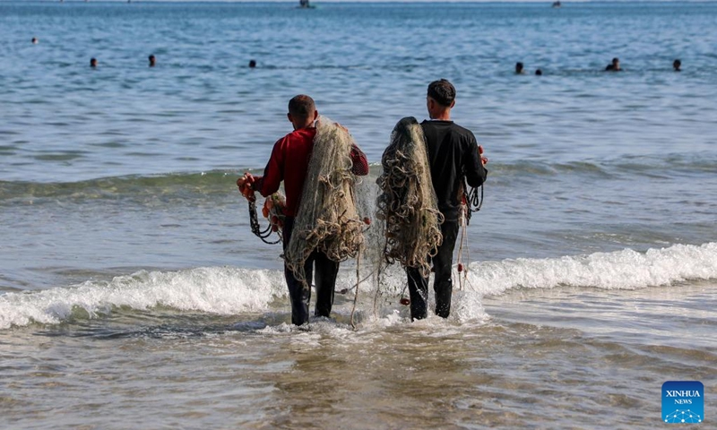 Palestinian fishermen are seen fishing on the beach in Gaza City, on April 24, 2026. (Photo by Rizek Abdeljawad/Xinhua)