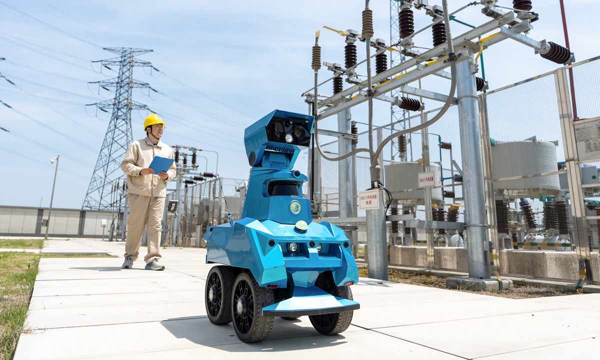 A worker inspects a 220-kilovolt substation with an intelligent robot in Hai'an, East China's Jiangsu Province, on April 26, 2026, to ensure reliable electricity supply during the upcoming May Day holidays. More and more robots have been deployed in various aspects of China's economic and social development. 
Photo: VCG
