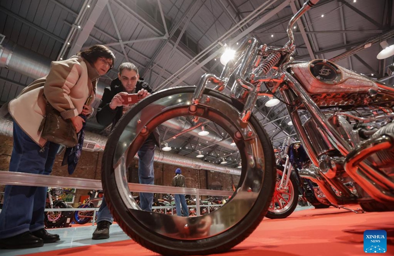 Visitors take photos of a motorcycle during the St. Petersburg Motorcycle Exhibition in St. Petersburg, Russia, on April 24, 2026. (Photo by Irina Motina/Xinhua)