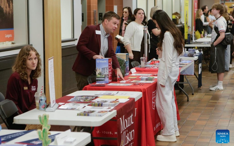 A student consults with a representative during the Global Universities Fair in Vancouver, British Columbia, Canada, April 25, 2026. Representatives from different universities and colleges from multiple countries attended the event, offering students and parents opportunities to explore international higher education options and admission pathways. (Photo by Liang Sen/Xinhua)