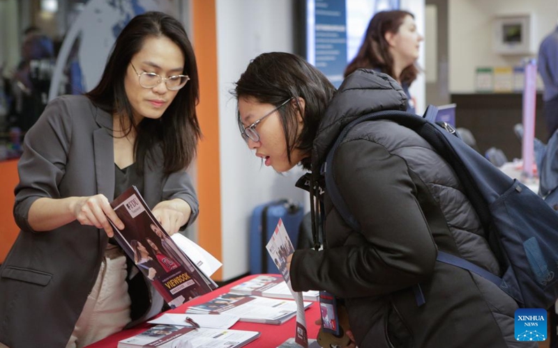 A student consults with a representative during the Global Universities Fair in Vancouver, British Columbia, Canada, April 25, 2026. Representatives from different universities and colleges from multiple countries attended the event, offering students and parents opportunities to explore international higher education options and admission pathways. (Photo by Liang Sen/Xinhua)