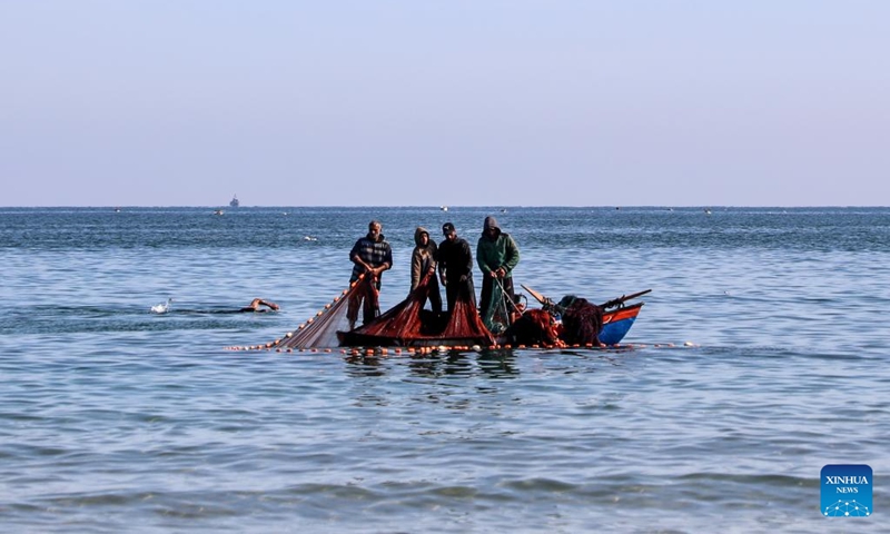 Palestinian fishermen are seen fishing on a boat near the Gaza port in Gaza City, on April 24, 2026. (Photo by Rizek Abdeljawad/Xinhua)