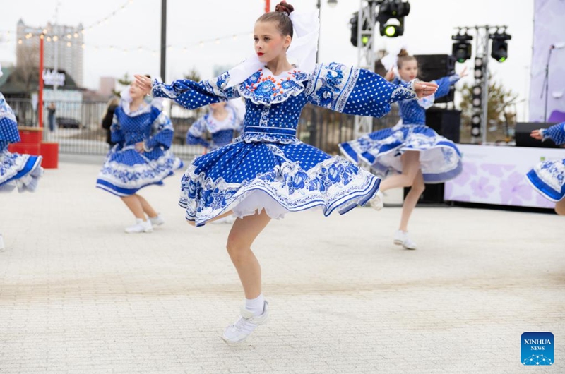 Performers dance during the rhododendron festival in Vladivostok, Russia, April 25, 2026. The rhododendron festival was held here on Saturday to promote rhododendron-themed tourism and enhance its appeal to tourists. (Photo by Andrey Matveenko/Xinhua)