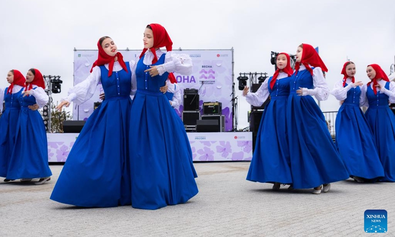 Performers dance during the rhododendron festival in Vladivostok, Russia, April 25, 2026. The rhododendron festival was held here on Saturday to promote rhododendron-themed tourism and enhance its appeal to tourists. (Photo by Andrey Matveenko/Xinhua)