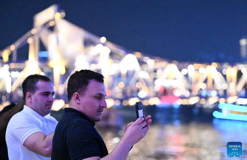 Tourists from Canada enjoy night view along the Haihe River in Tianjin, north China, April 24, 2026. In recent years, Tianjin has become a popular tourist destination, as the city keeps enriching its nighttime experience by expanding tourism scenarios and diversifying business formats. (Xinhua/Sun Fanyue)