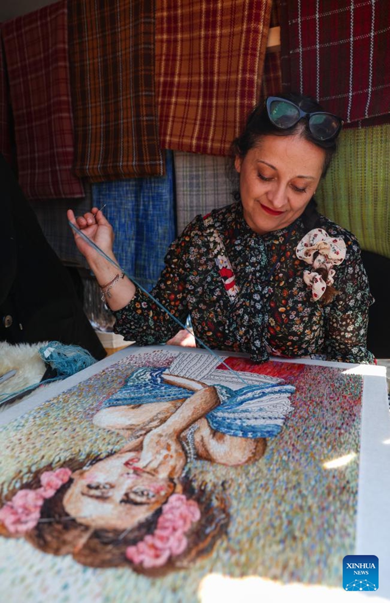 A craftsman makes a woolen embroidery artwork at a wool festival in Santiago, Chile, April 25, 2026. (Xinhua/Zhou Jiayi)