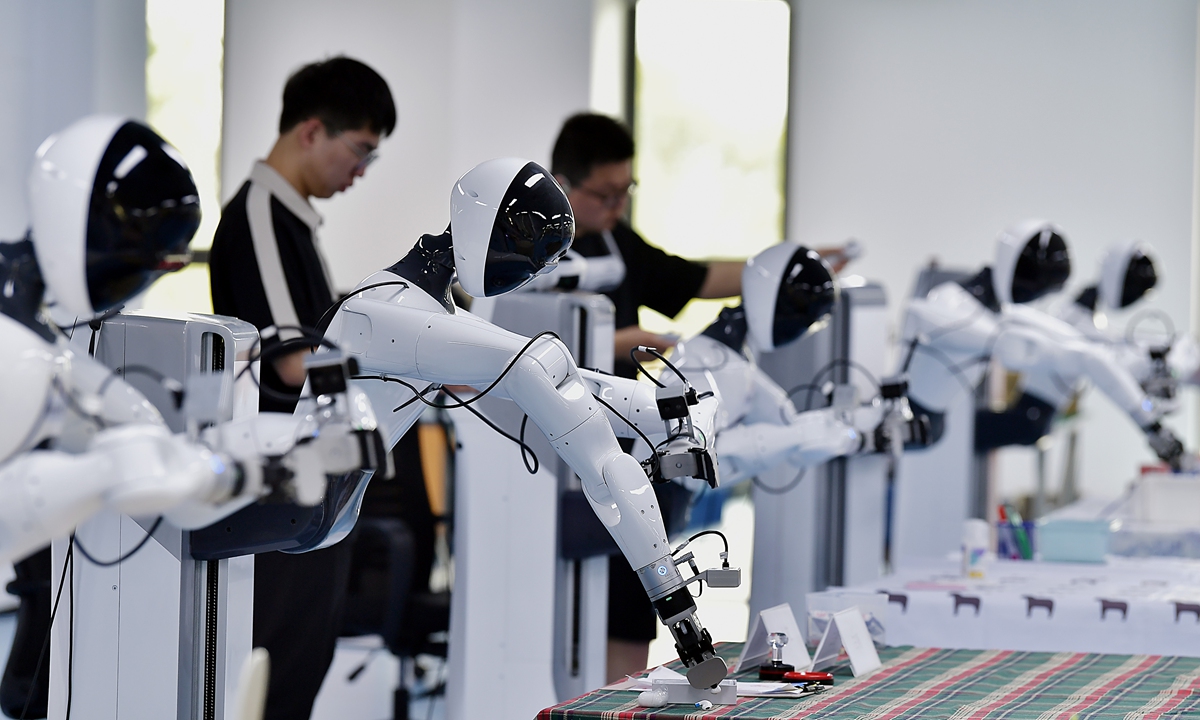 Data collection workers train embodied robots on April 27, 2026, teaching tasks such as sorting food and grasping bottles at a software park in Fuzhou, East China's Fujian Province. The factory acts as a 