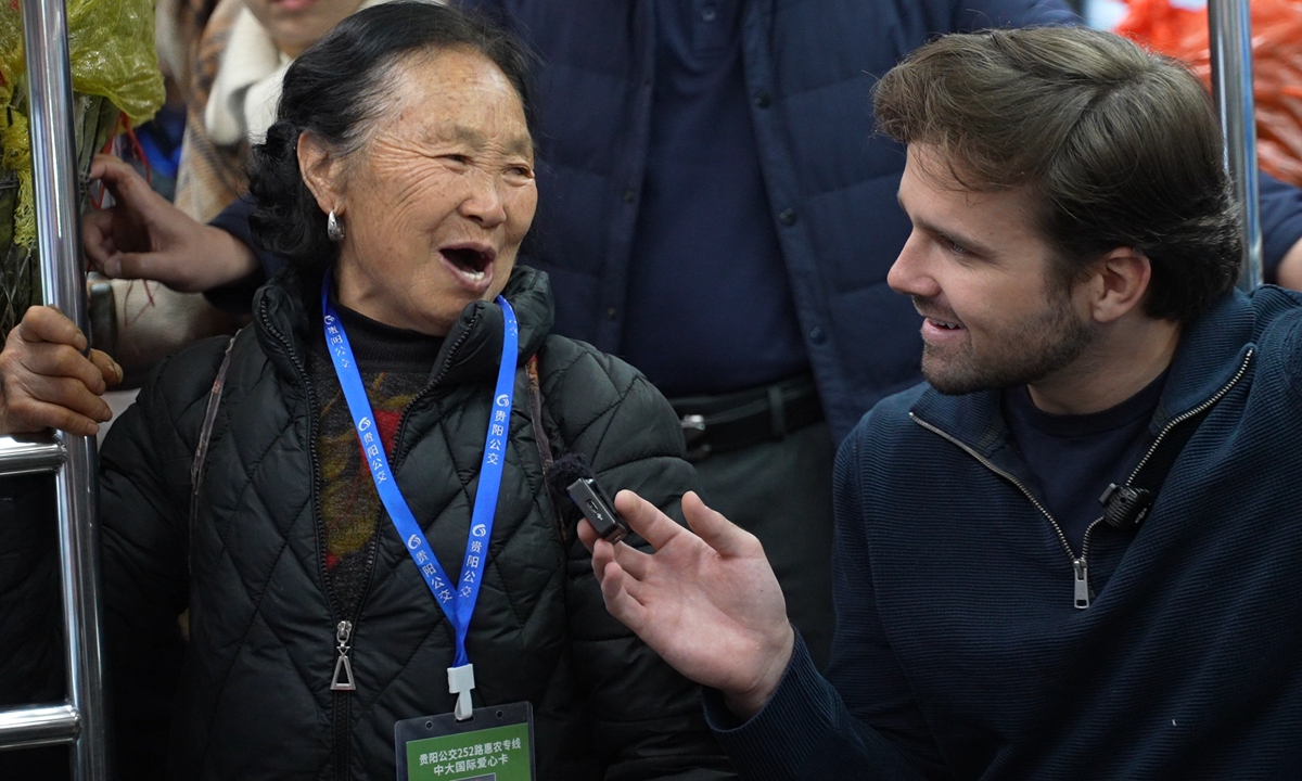 Jackson Hinkle talks with an elderly farmer on the Route 252 bus. Photo: Courtesy of Hinkle