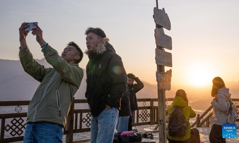 Tourists take photos at the Nanshan park in Lhasa, southwest China's Xizang Autonomous Region, April 26, 2026. (Xinhua/Tenzin Nyida)