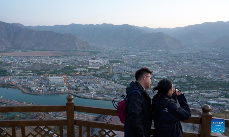 Tourists take photos at the Nanshan park in Lhasa, southwest China's Xizang Autonomous Region, April 26, 2026. (Xinhua/Tenzin Nyida)