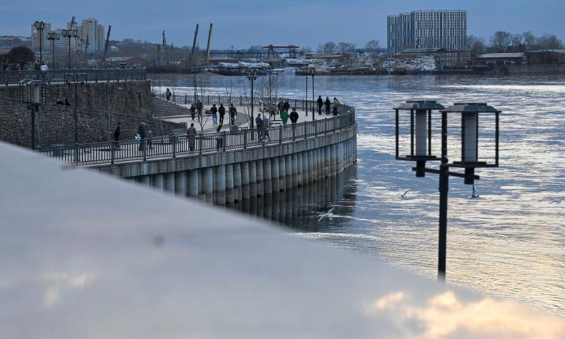 People stroll along the river in Irkutsk, Russia, April 25, 2026. (Xinhua/Hao Jianwei)