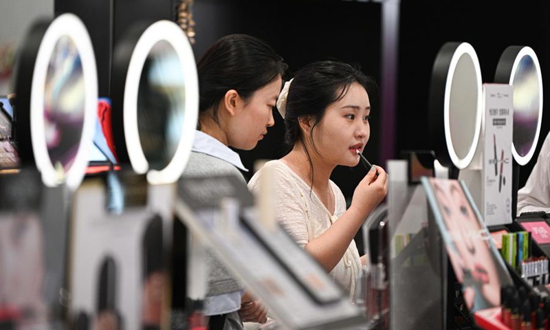 A customer tries makeup at a duty-free shop in Haikou, south China's Hainan Province, April 25, 2026. (Xinhua/Pu Xiaoxu)